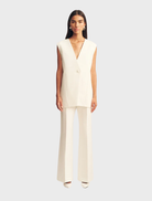 Ivory sleeveless blazer by Otis, featuring a tailored design suitable for formal or casual occasions.