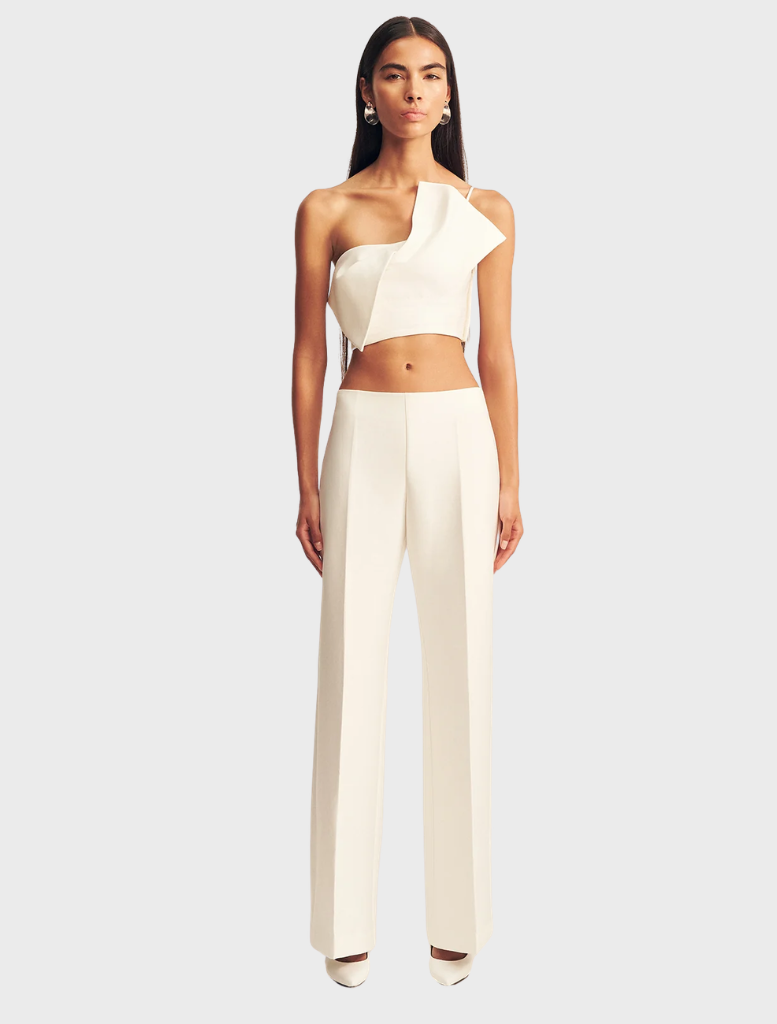 Ivory Otis Pant displayed on a hanger, showcasing its sleek design and fabric texture.