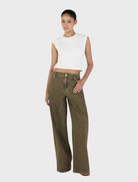 Khaki Paige Denim jeans laid out, emphasizing their stylish design, pockets, and soft fabric texture against a neutral backdrop.