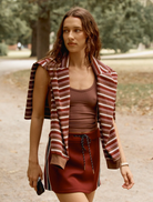 Burgundy Palmer mini skirt displayed on a white background, showcasing its stylish design and fabric texture.