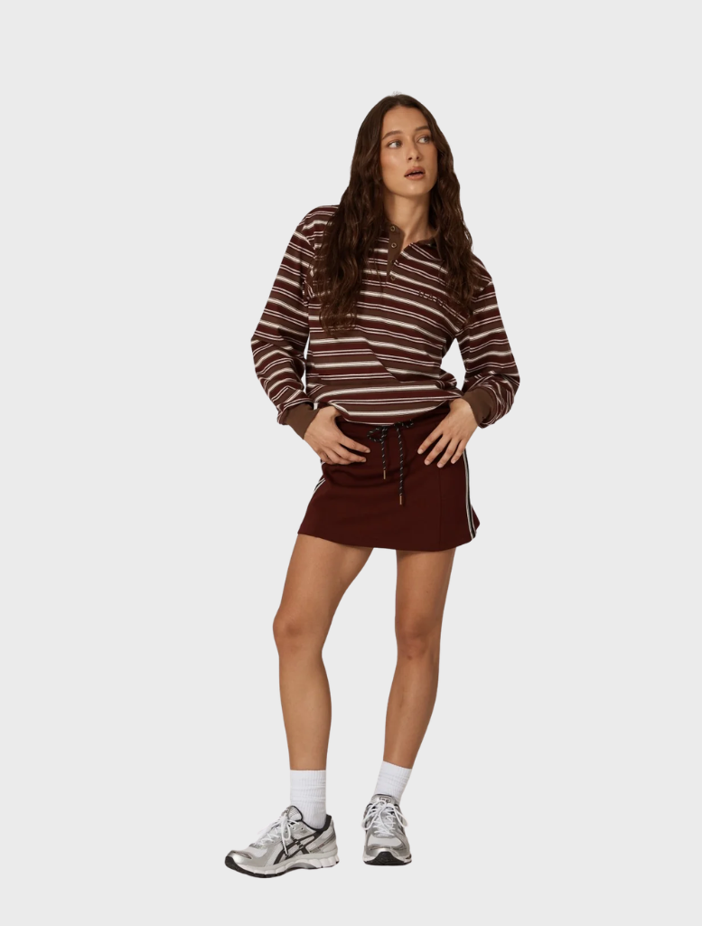 Elegant burgundy mini skirt by Palmer, emphasizing its contemporary cut and rich color on a plain background.