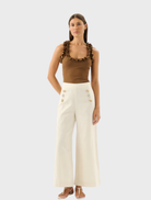 Toffee Paloma Tank top displayed on a hanger, featuring a simple and elegant design suitable for casual wear.
