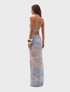 Flowing long dress showcasing a bold print, designed for comfort and fashion in warm weather.