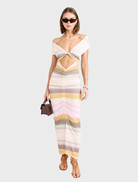 Elara Dress in a soft peach hue, featuring a chic and flowing style for any occasion.