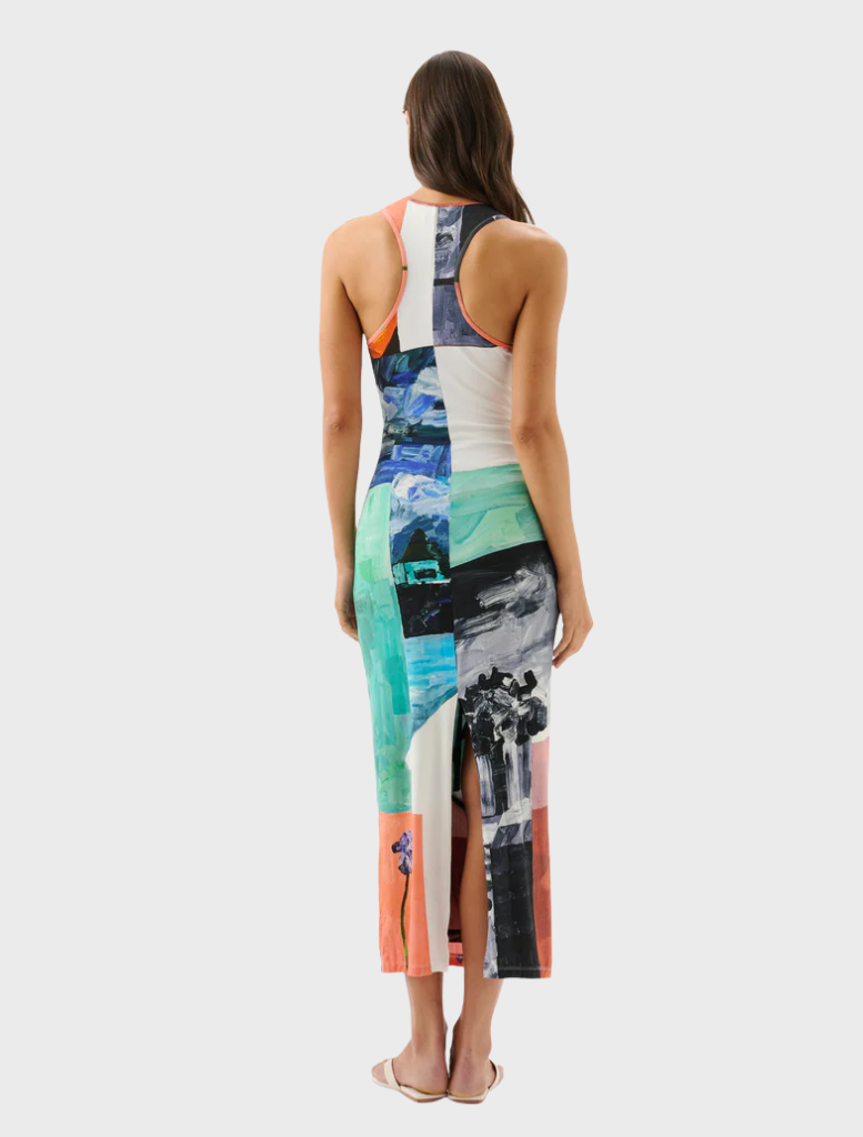  A woman showcases a colorful dress decorated with flowers, reflecting a vibrant and lively fashion choice.