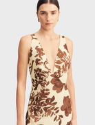 Elegant Noa Plunged Maxi Dress adorned with a colorful Pineapple Wallflower design, ideal for warm-weather events.