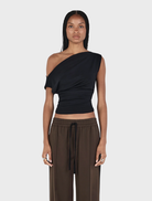 Black Pip wool top displayed on a hanger, showcasing its soft texture and simple design.