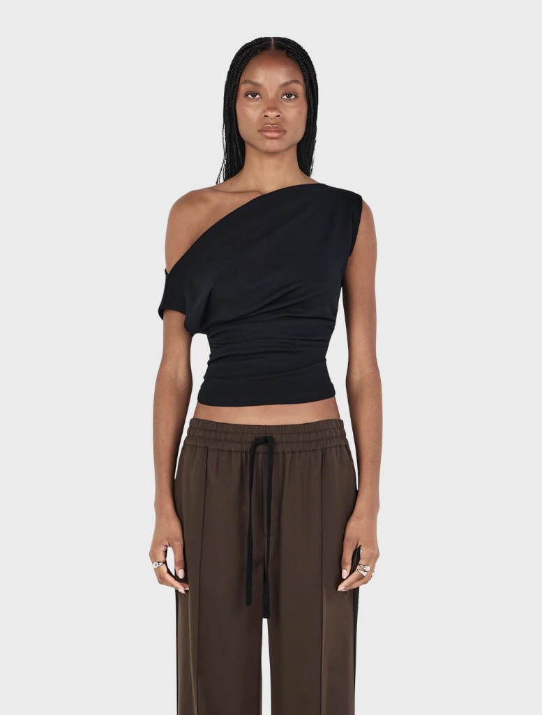 Black Pip wool top displayed on a hanger, showcasing its soft texture and simple design.