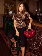 Trendy poppy blouse with bubble sleeves in a bold leopard print, ideal for adding flair to any wardrobe.