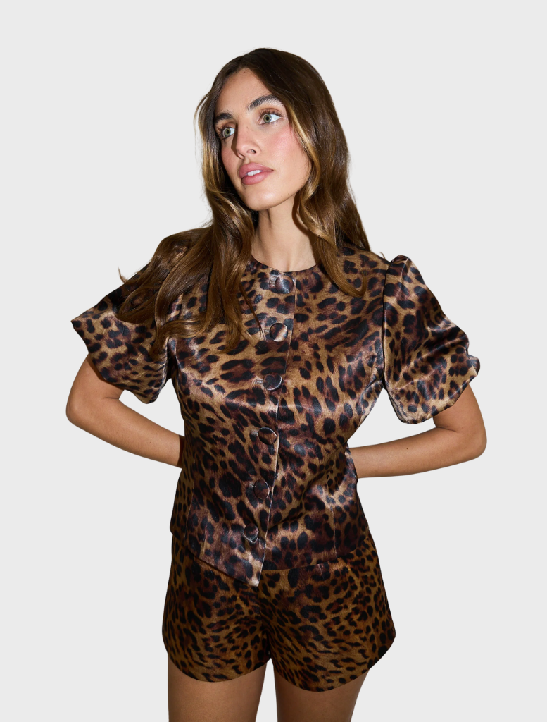 Chic Poppy bubble sleeve blouse adorned with a striking leopard pattern, suitable for casual or dressy occasions.
