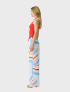 Pippi Tank Top in Poppy, combining a scoop neck, racerback style, and lace detailing for a chic and comfortable outfit.