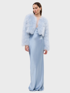 Luxurious powder blue crop jacket with marabou feathers, structured shoulders, and hook-and-eye closure for stylish layering.