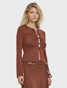 A close-up of an espresso Prism blouse, highlighting its soft fabric and stylish cut.