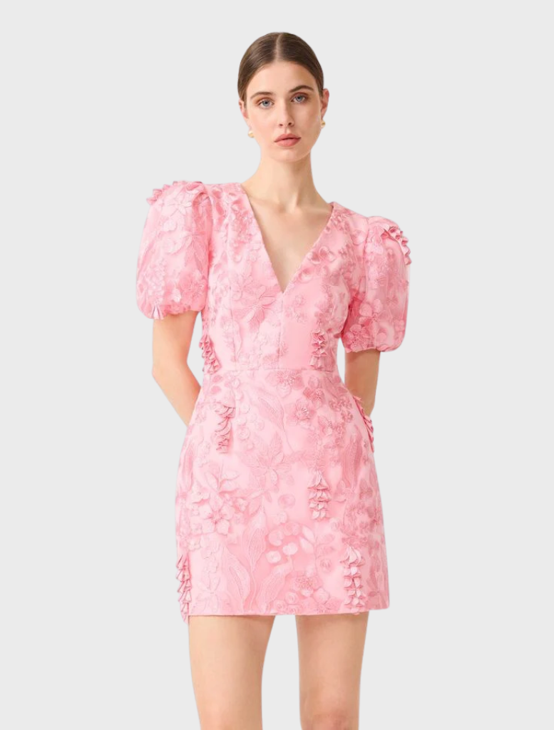 Chic pink mini dress by Monique, featuring puff sleeves and a flattering fit, suitable for various occasions.
