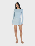 Ice blue long sleeve top from Quinn, designed for comfort with a versatile style suitable for various occasions.