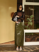 Khaki Raye maxi skirt displayed on a mannequin, showcasing its flowing design and elegant silhouette.