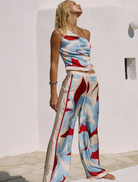 Amoree One Shoulder Tie Top, presented in bright Amoree Red, with a trendy one-shoulder cut and stylish tie feature.