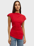 A red Liana top hanging, highlighting its elegant cut and fabric texture.