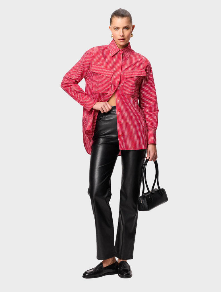 Red striped Tudor shirt draped on a mannequin, illustrating its stylish cut and vibrant color scheme.