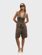 Model wearing a brown Reeve Halter Top and matching shorts, showcasing a stylish summer outfit.