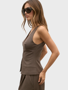 The image features a model in a brown Reeve Halter Top and shorts, presenting a trendy summer ensemble.