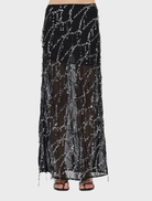 Flowing black maxi skirt with a bias design, perfect for a chic and sophisticated outfit.