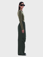 Wide-leg pull-on pant in olive check pattern, designed for comfort with an elastic waistband and adjustable hems for a relaxed fit.