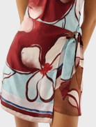 Remy Mini Dress in Marisol Bloom features a floral pattern with a fitted silhouette and short sleeves, perfect for summer outings.