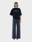 Black tee featuring a sparkling rhinestone logo, perfect for casual or stylish occasions.