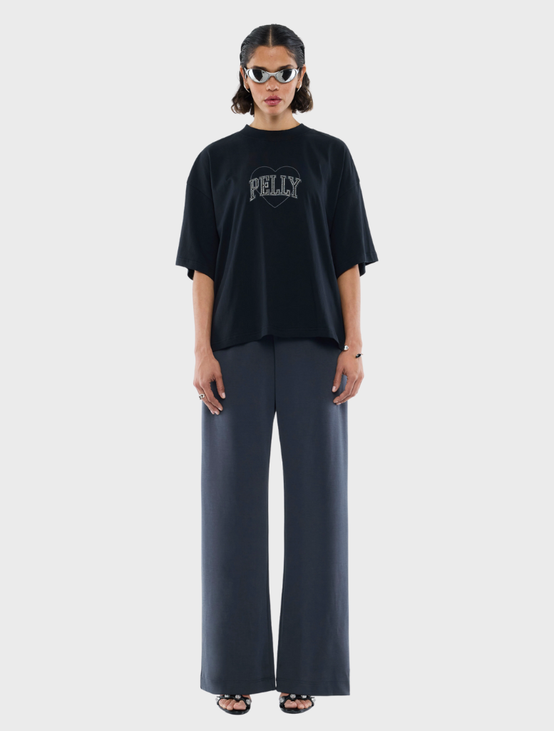 Elegant black tee with a decorative rhinestone logo, suitable for both casual and dressy settings.