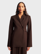 Ristretto-colored double-breasted blazer with a structured design and elegant lapels, ideal for formal occasions.
