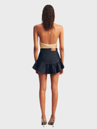 Deep indigo mini skirt with elegant ruffles, combining comfort and style for versatile fashion choices.