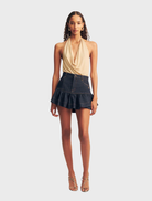  Deep indigo mini skirt with ruffle detailing, showcasing a stylish and feminine design.