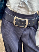 A blue leather belt with a silver buckle, showcasing a classic design suitable for various occasions.