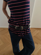 Blue leather belt adorned with a shiny silver buckle, combining elegance and practicality in one accessory.