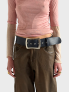 Blue leather belt adorned with a shiny silver buckle, combining elegance and practicality in one accessory.