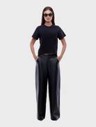 Black leather pants designed for a sleek, stylish look, featuring a fitted silhouette and modern design elements.