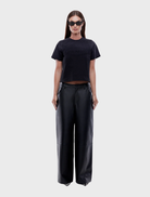 Elegant black leather pants with a tailored fit, perfect for both casual and formal occasions.
