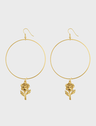 Gold hoop earrings featuring a delicate rose charm, named Rosa Linda Earrings.