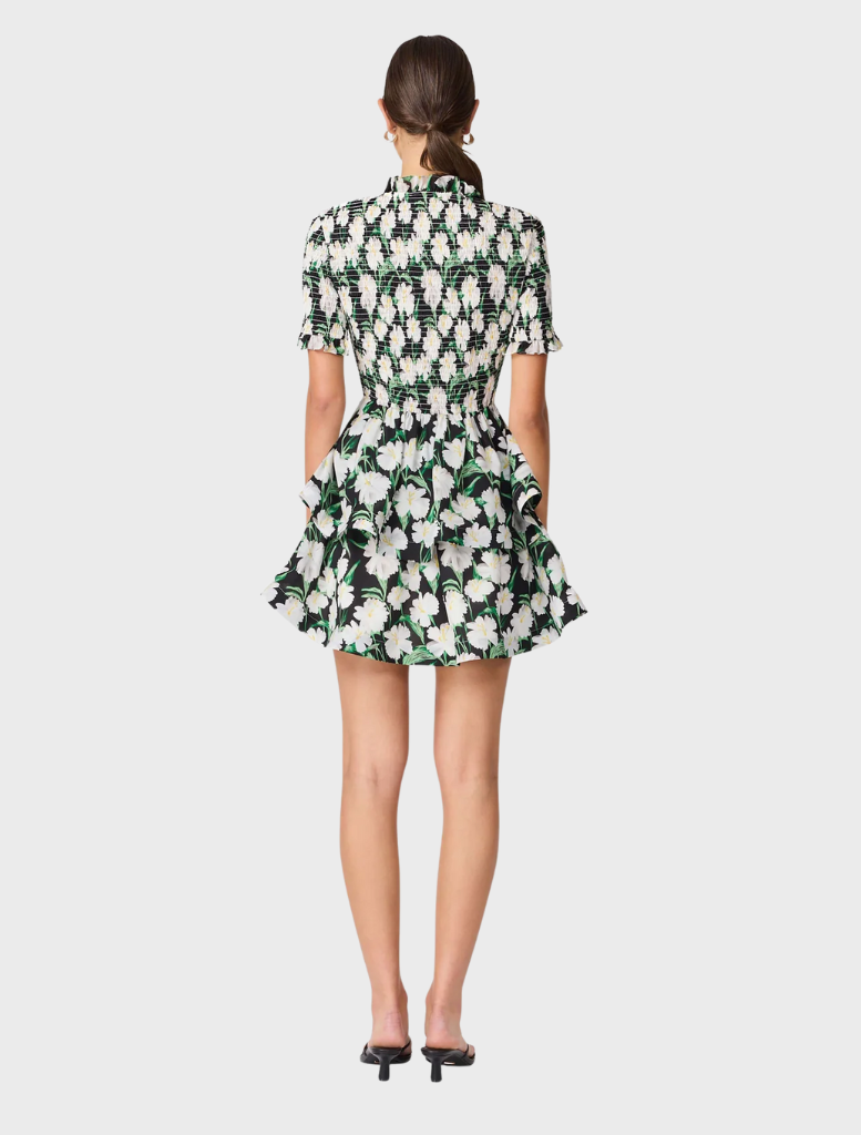 A stylish floral mini dress with short sleeves, showcasing a playful design ideal for warm weather occasions.

