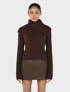 Chocolate-colored Roxanne turtleneck sweater displayed on a neutral background, showcasing its soft fabric and fitted design.