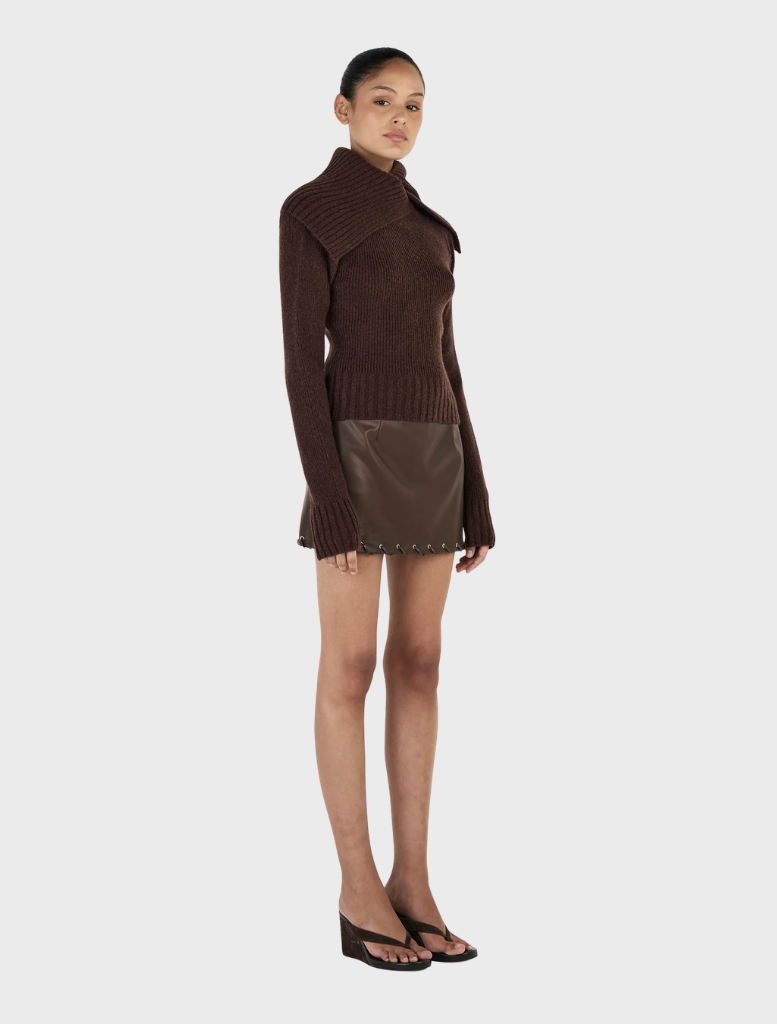 Chocolate Roxanne turtleneck sweater, emphasizing its stylish fit and cozy fabric, displayed on a light-colored surface.