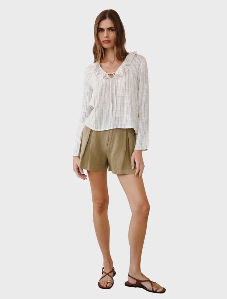 Ecru top with black pinstripes and a ruffle tie neck, combining elegance and versatility for various occasions.