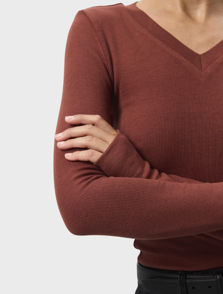 A rust Sedona Top shown on a hanger, showcasing its soft fabric and casual design with short sleeves.