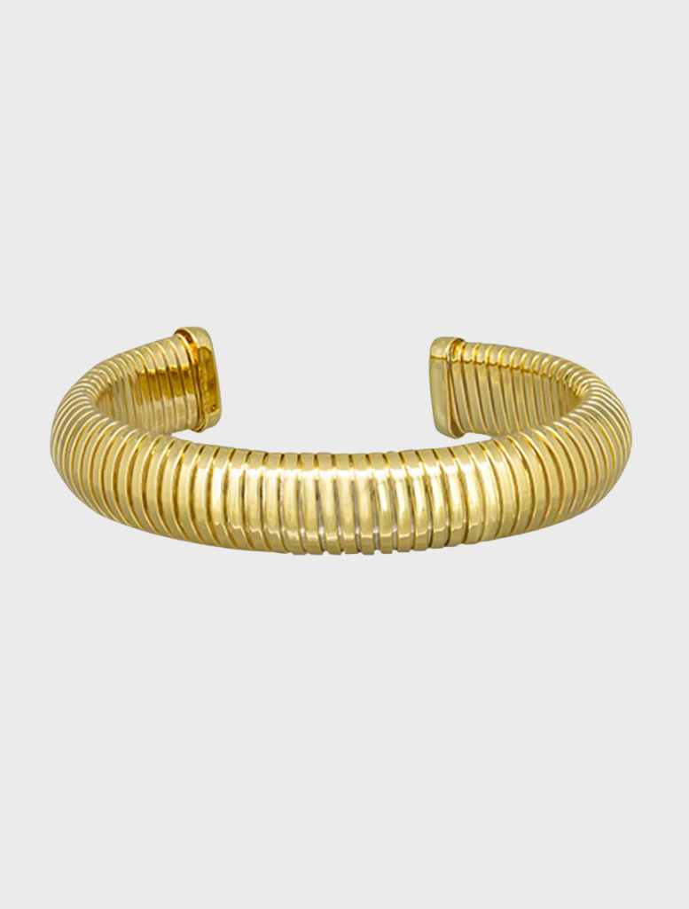 A gold cuff bracelet designed by Sabrina, showcasing a sleek and modern aesthetic.