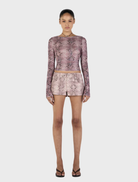 Mauve long sleeve top adorned with a snake print, combining comfort and style for any wardrobe.