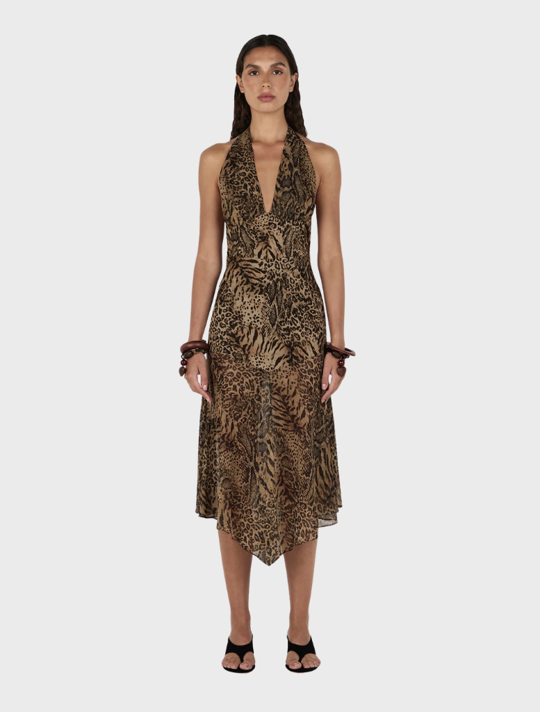 The Saffron Midi Dress is modeled, featuring an eye-catching leopard print design.
