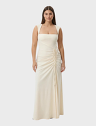 A stunning butter-colored Samara gown, characterized by its elegant lines and sophisticated draping.