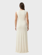 Elegant Samara gown in a soft butter color, featuring a flowing silhouette and delicate fabric draping.