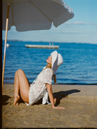 Elegant white Sara romper, ideal for warm weather, showcasing a chic and comfortable fit.